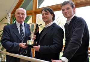 NIAB’s Simon Kerr presents the NIAB Variety Cup to KWS maize breeder, Matthias Landbeck and UK maize specialist, John Burgess